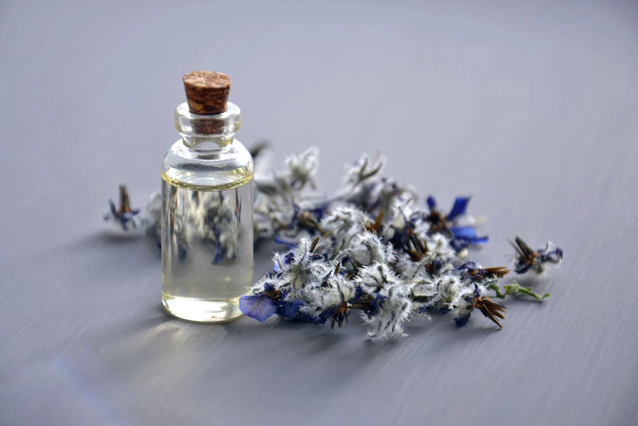 Lavender essential oil bottle with lavender flowers