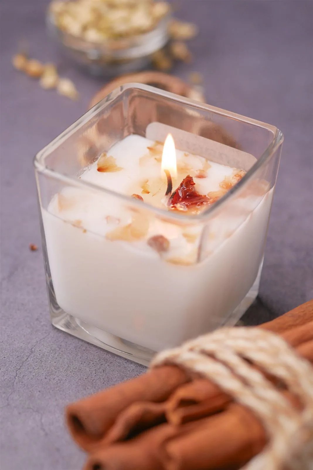 Lit soy candle in a glass jar