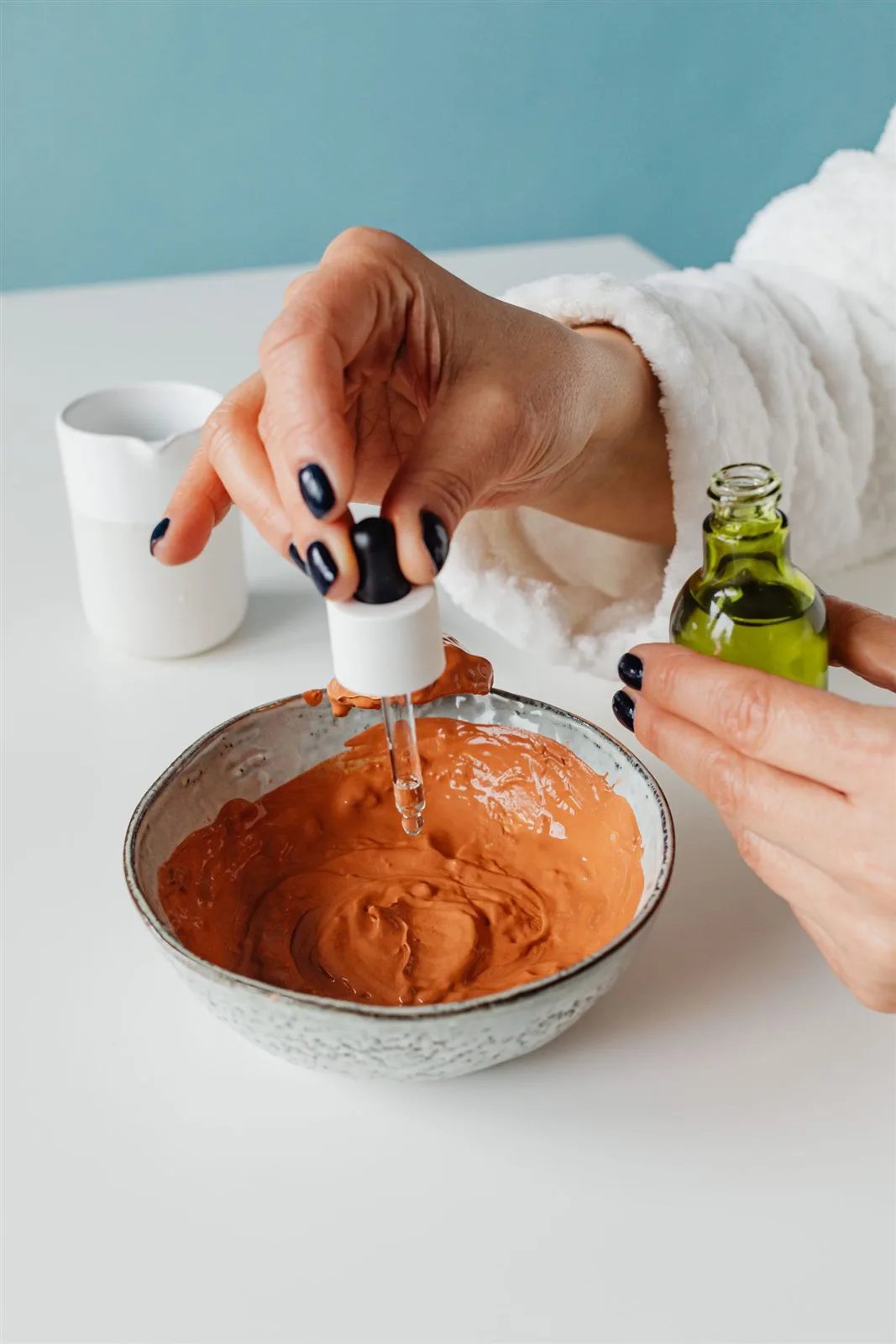 Bowl of clay face mask with a brush